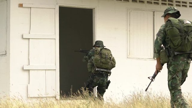 Soldier holding gun weapon and waring armor uniform. The military is responsible for maintaining the territory.