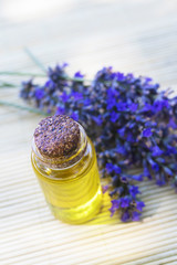 oil jars or lavender essence with a bouquet of natural lavender flowers