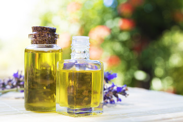 oil jars or lavender essence with a bouquet of natural lavender flowers