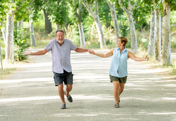 Happy senior couple walking and enjoying life outdoors