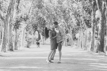 Fototapeta premium young pretty couple dancing in a green park
