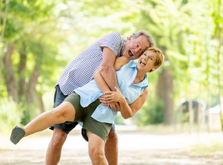 Portrait of a beautiful happy senior couple in love relaxing in the park