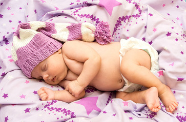 Obraz na płótnie Canvas portrait newborn baby sweetly a sleep in long gnome hat