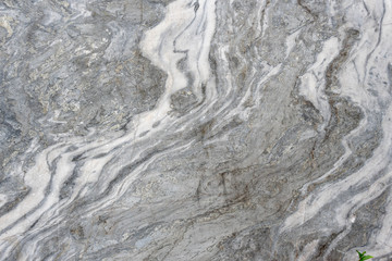 Gray surface of marble stone with striped streaks.