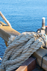 Fototapeta premium A rolled thick rope aboard an ancient wooden ship.