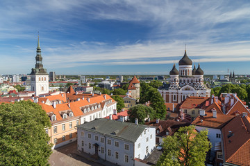 Fototapeta na wymiar St. Nicholas' Church, St. Alexander Nevsky Cathedral and other buildings at the Old Town in Tallinn, Estonia, viewed from above on a sunny day in the summer.