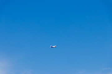 passenger airliner takes off to the blue sky background