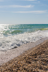 Beach with a wave in the summer Sunny day