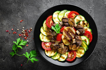Salad with fresh and grilled vegetables and mushrooms. Vegetable salad with grilled champignons. Vegetable salad on plate