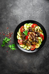 Salad with fresh and grilled vegetables and mushrooms. Vegetable salad with grilled champignons. Vegetable salad on plate