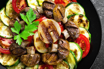 Salad with fresh and grilled vegetables and mushrooms. Vegetable salad with grilled champignons. Vegetable salad on plate