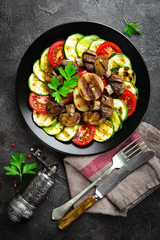 Salad with fresh and grilled vegetables and mushrooms. Vegetable salad with grilled champignons. Vegetable salad on plate