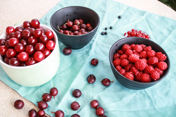 Flatlay with raspberries, blueberries and gooseberries.