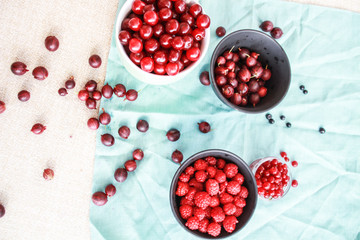 Flatlay with raspberries, blueberries and gooseberries.