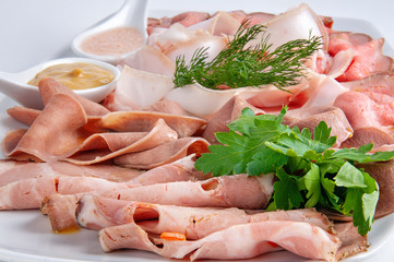 Assorted homemade meat platter with sauce and mustard