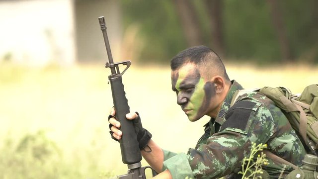 Soldier holding gun weapon and waring armor uniform. The military is responsible for maintaining the territory.