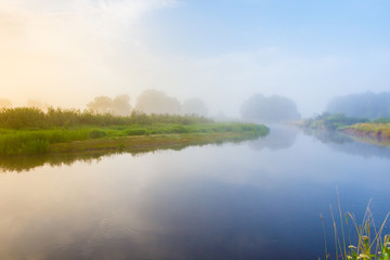 Morning fog over the river curve. Foggy morning landscape