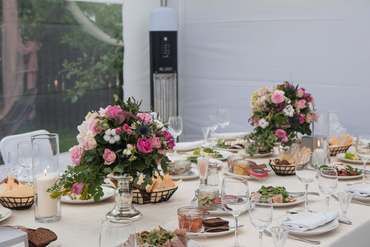 Wedding Table In Countryside Restraunt  Decorated With Pink Flowers Glasses 