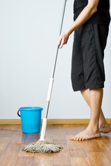 the man washes the floor in the apartment