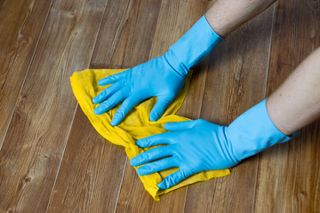 the man washes the floor with a rag in the apartment