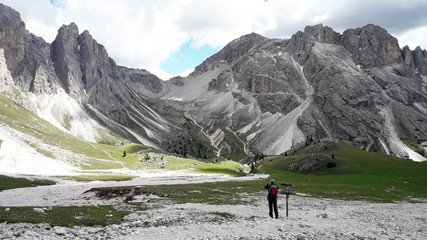 Naklejka premium climbers before the ascent, stand in the valley in front of the cliffs