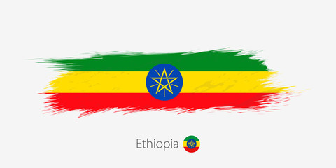 Flag of Ethiopia, grunge abstract brush stroke on gray background.