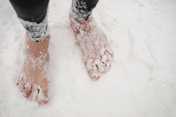 Men's bare feet in the snow