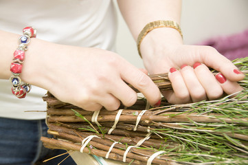 Small business. Woman florist hands close-up, bunch of roses in a flower shop. Assistant person or owner in a flower design studio, making decorations and arrangements. Flower delivery, order creation