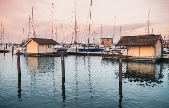 Sailing yachts and floating houses in marina