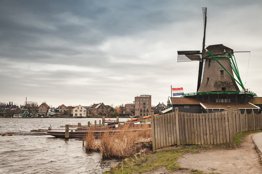 Windmill on river coast, Netherlands