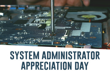 Fototapeta na wymiar System Administrator Appreciation Day. Postcard for the holiday. The guy is fixing the laptop.