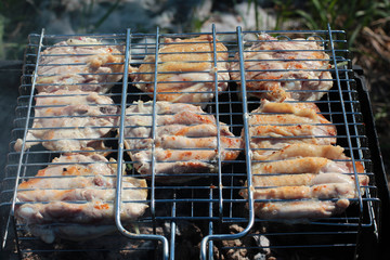 delicious juicy chargrilled shashlik or marinated meat on grill barbecue on barbecue grill, view from above, close-up