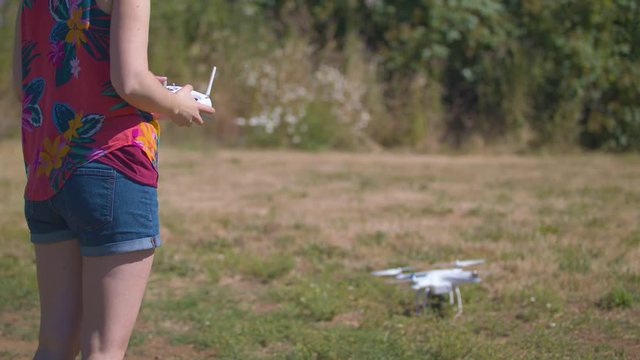 Slow-motion footage of a woman controlling a drone and taking off.  Shot on a Blackmagic Ursa Mini Pro 4.6k with a Sigma 50-100mm f/1.8.