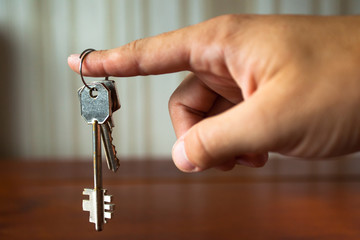the keys to the apartment door in the man's hand