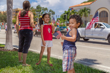 Young latino family watching the parade with pride.