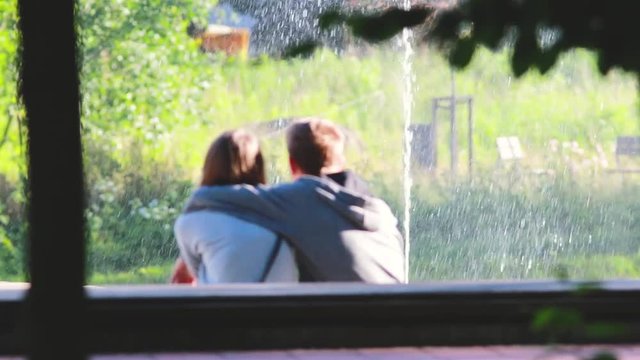 Dating couple in love at the fountain in park garden