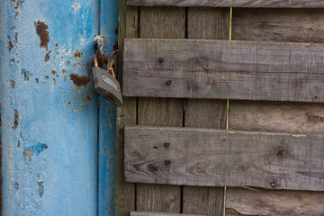 Photo of locked metal doors and rust keylock
