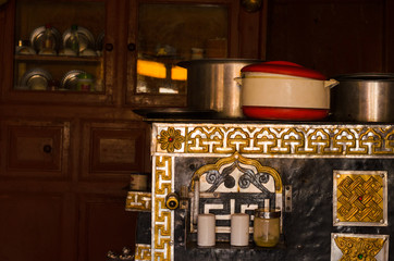 A typical Ladak kitchen with copper stove and utensils, in a traditional guest house in northern India.