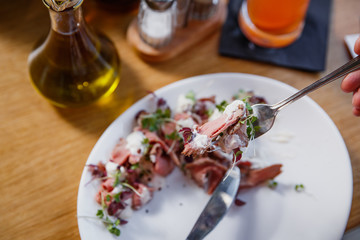 Beef carpaccio on white plate.