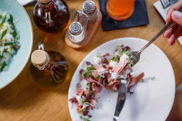 Beef carpaccio on white plate.