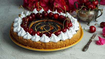 Obraz na płótnie Canvas Poppy seed cheese cake, with cherry sliced and served on plate