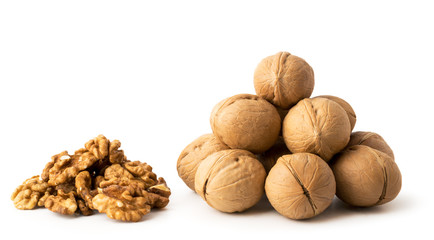 A bunch of walnuts in a peel and a bunch of peeled on a white, isolated.