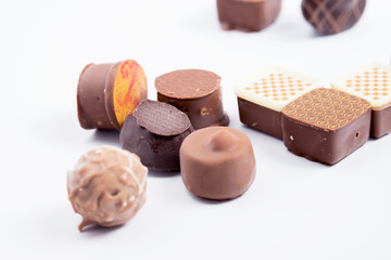 A set of chocolate candies on a white background, close-up.