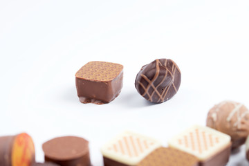 A set of chocolate candies on a white background, close-up.