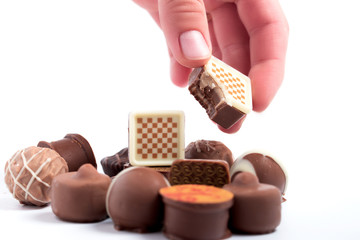 A set of chocolate candies on a white background, close-up.