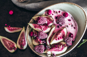 Healthy breakfast bowl  with yogurt, fresh figs and frozen berries