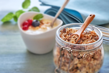 Jar of muesli with yogurt, honey and berries, healthy dessert