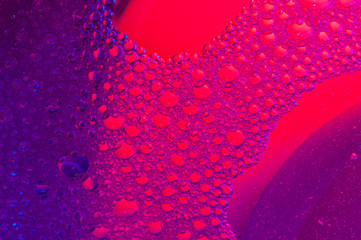 Bubbles on water surface red and violet color