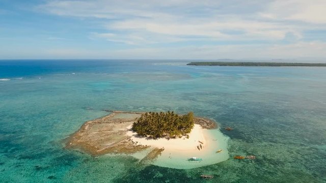 Aerial view of beautiful tropical island Guyam with white sand beach. View of a nice tropical beach from the air. Seascape: Ocean and beautiful beach paradise. Philippines. 4K video. Travel concept