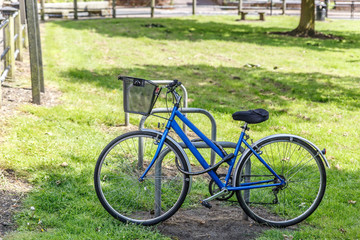View of a blue bicycle tied to a metal anchor